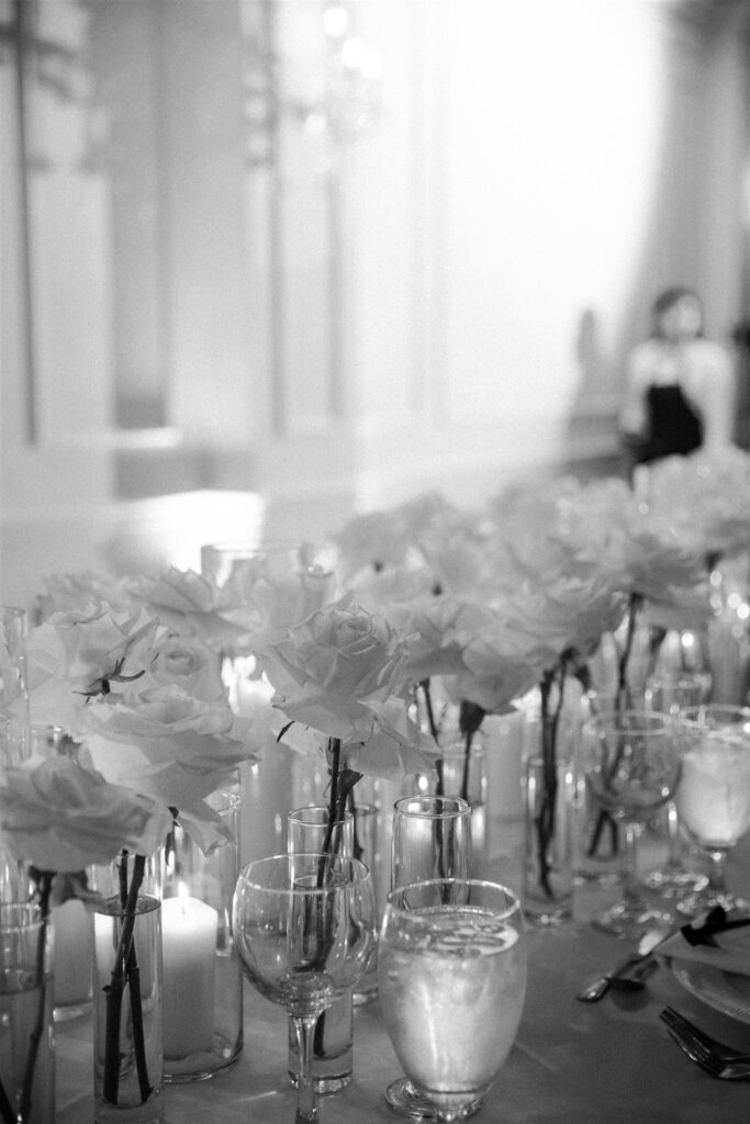 White roses and candles on the reception tables