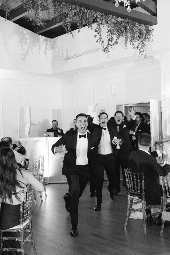 Groom dancing into the reception