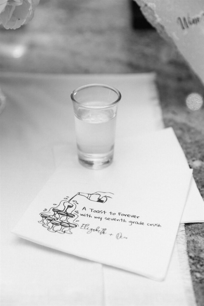 Shot glass and cocktail napkin detail