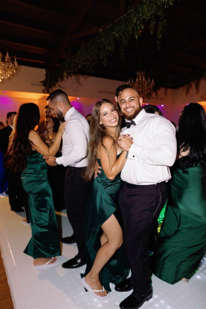 Guests dancing in green and black gowns