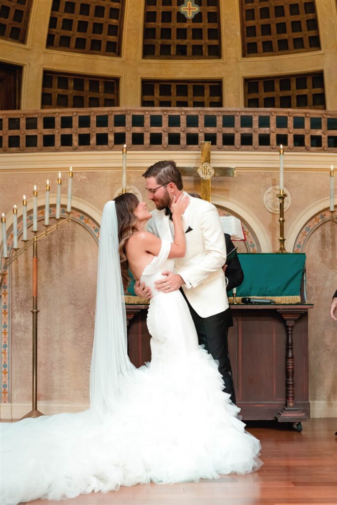 Bride and groom's first kiss at the altar