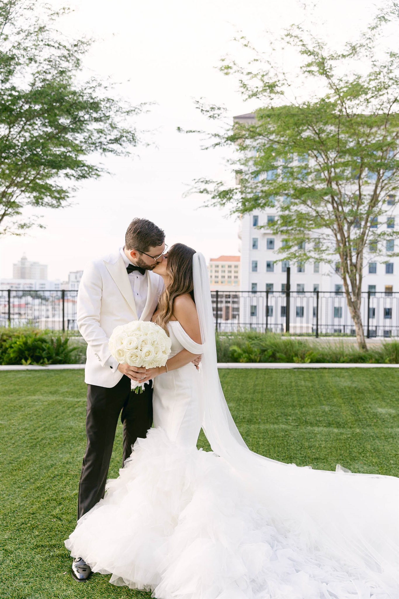 Bride and groom embracing on the lawn at Loews Coral Gables