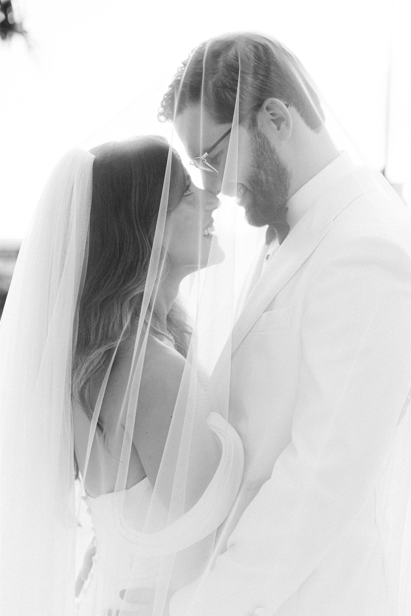Bride and groom touching foreheads in a soft portrait