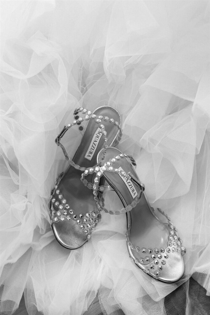 Bridal shoes resting on tulle