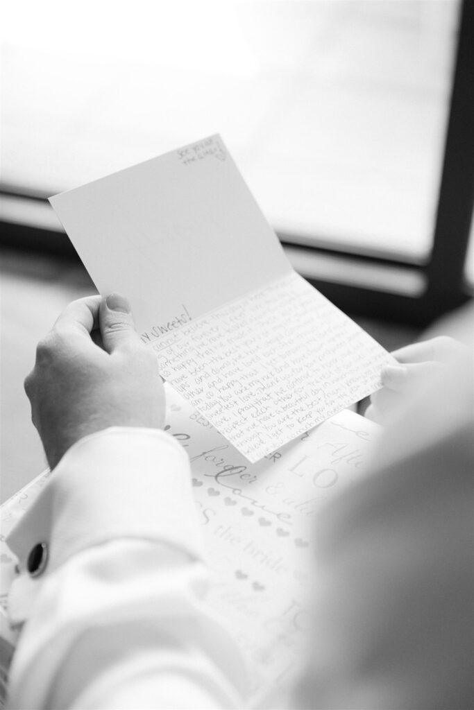 Groom reading a letter on his wedding morning