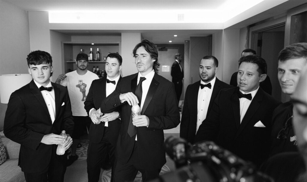 Groom with his groomsmen in black tuxedos