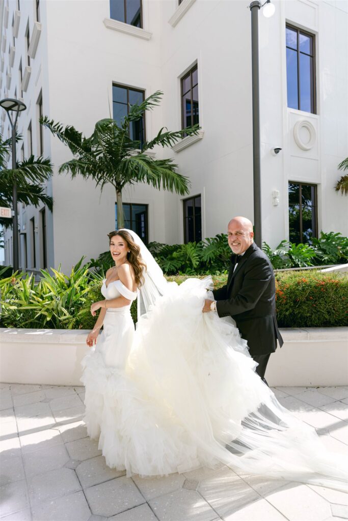 Bride walking in her mermaid gown outside the hotel
