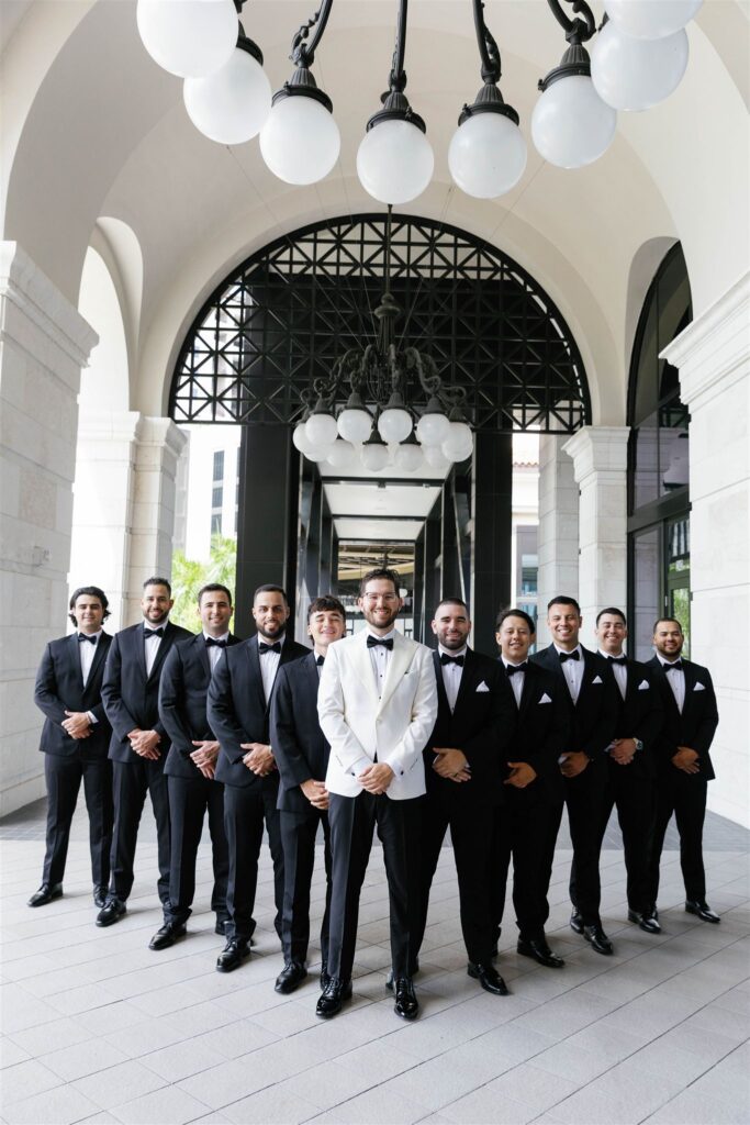 Groom and groomsmen under the arches of Loews Coral Gables