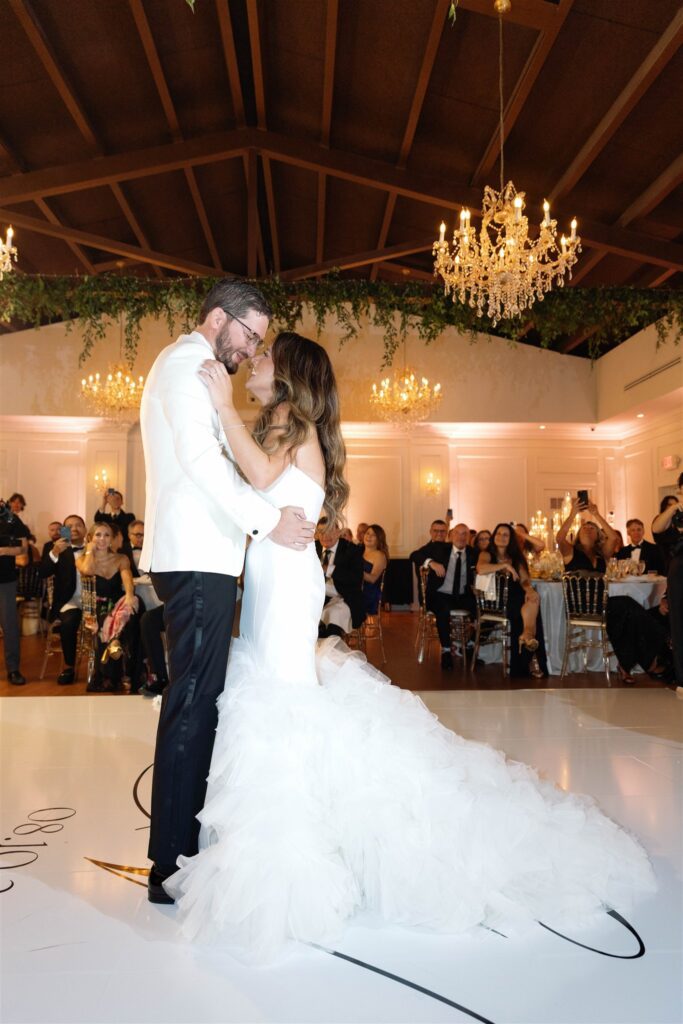 Bride and groom's first dance under the chandelier at The Club of Knights