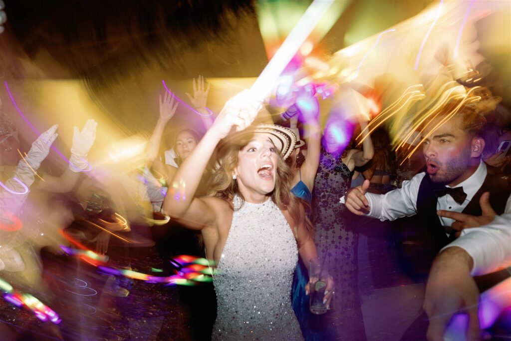 Bride dancing under colorful lights