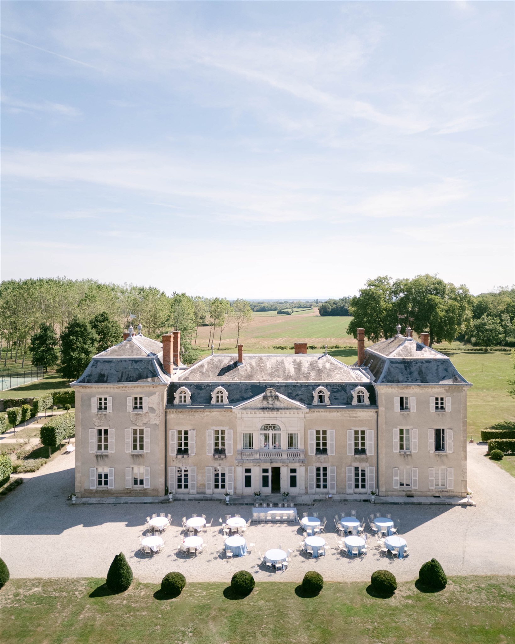 Aerial view of Château de Varennes with reception tables set on the terrace
