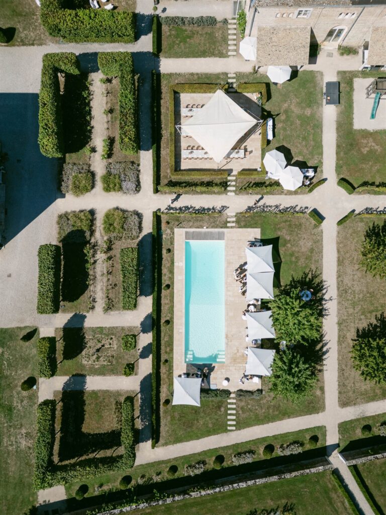 Aerial view of the château gardens and pool during brunch