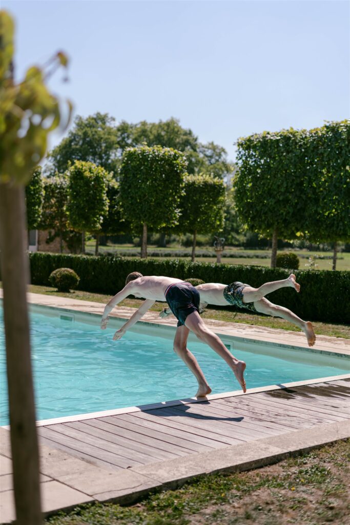 Guest mid-jump into the pool at Château de Varennes
