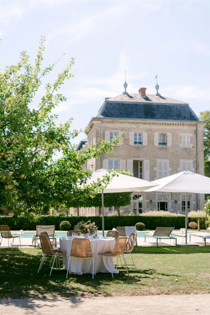 Brunch tables set on the lawn in front of Château de Varennes