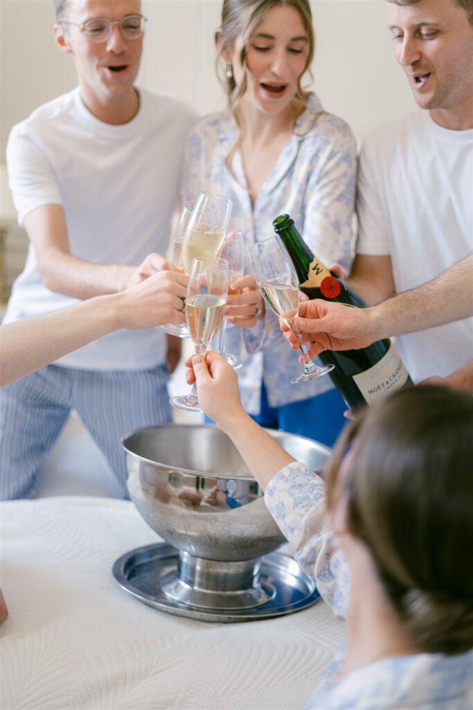 Romy and her friends toasting with Champagne while getting ready