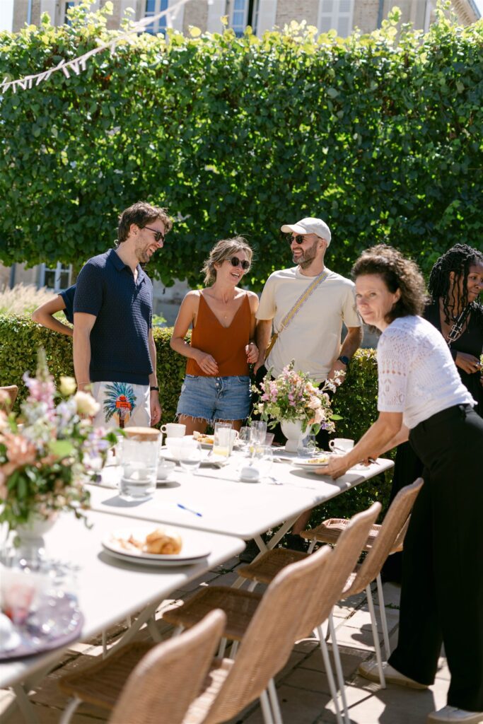 Guests chatting around the brunch table decorated with flowers