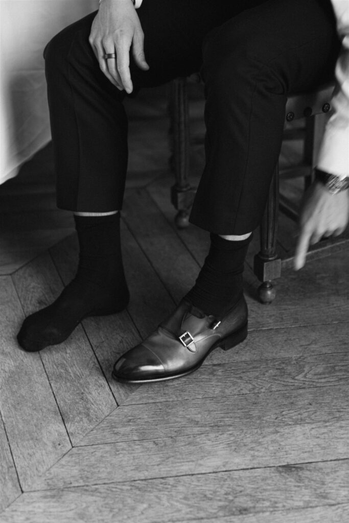 Black and white detail of Jonathan's leather shoes and socks