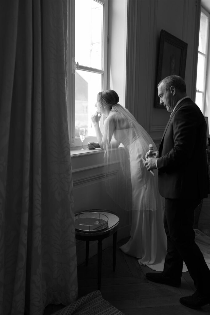 Black and white photo of Romy and a family member sharing a quiet moment by the window