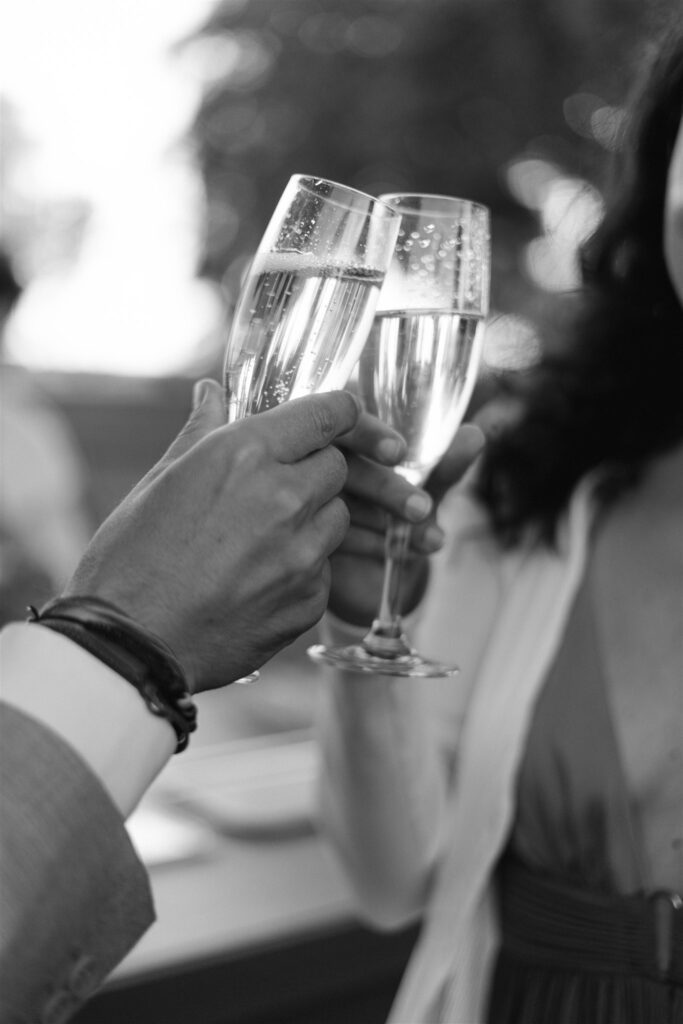 Black and white photo of Champagne glasses clinking