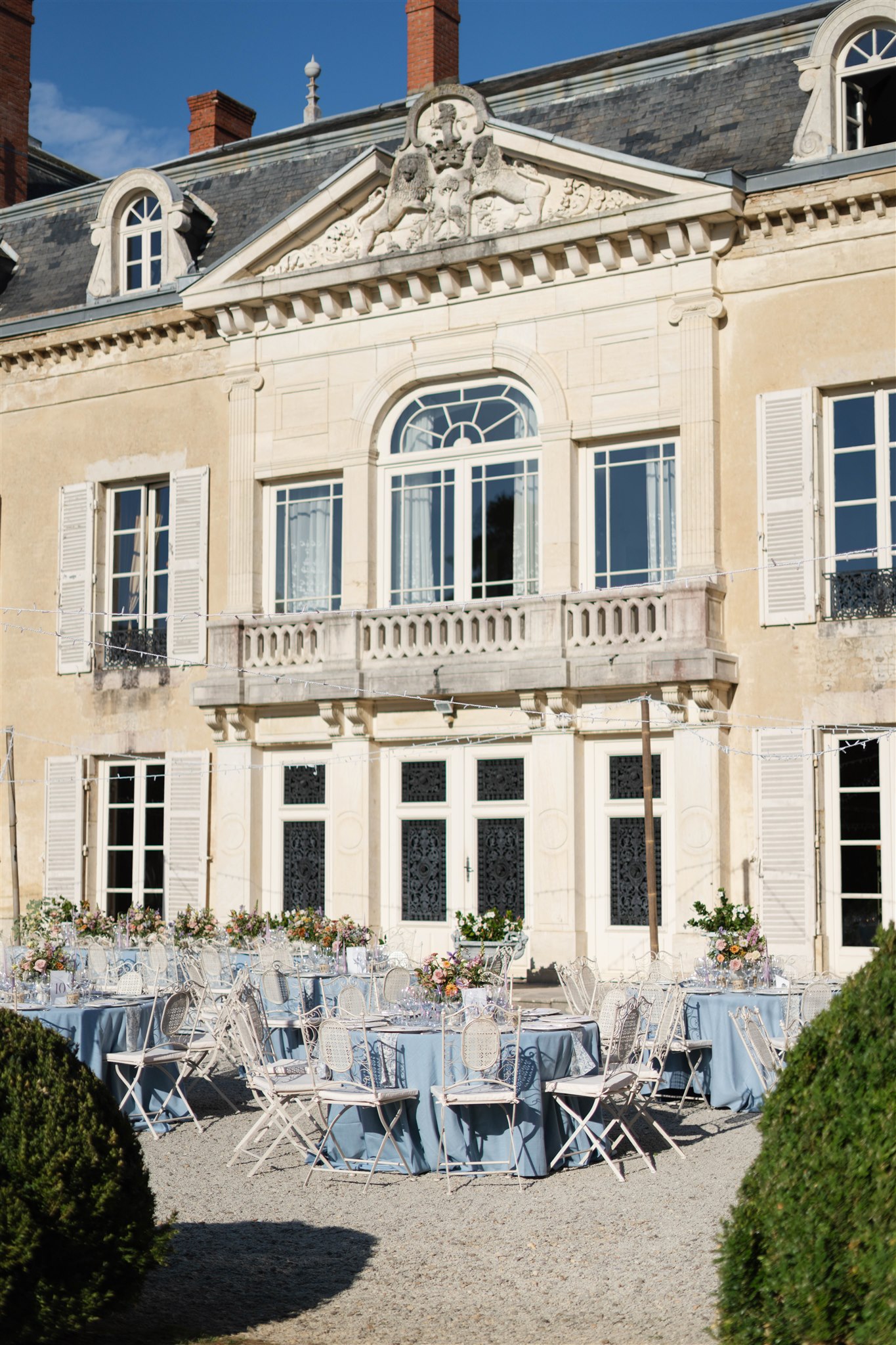 Château de Varennes terrace with blue-draped reception tables and bistro chairs