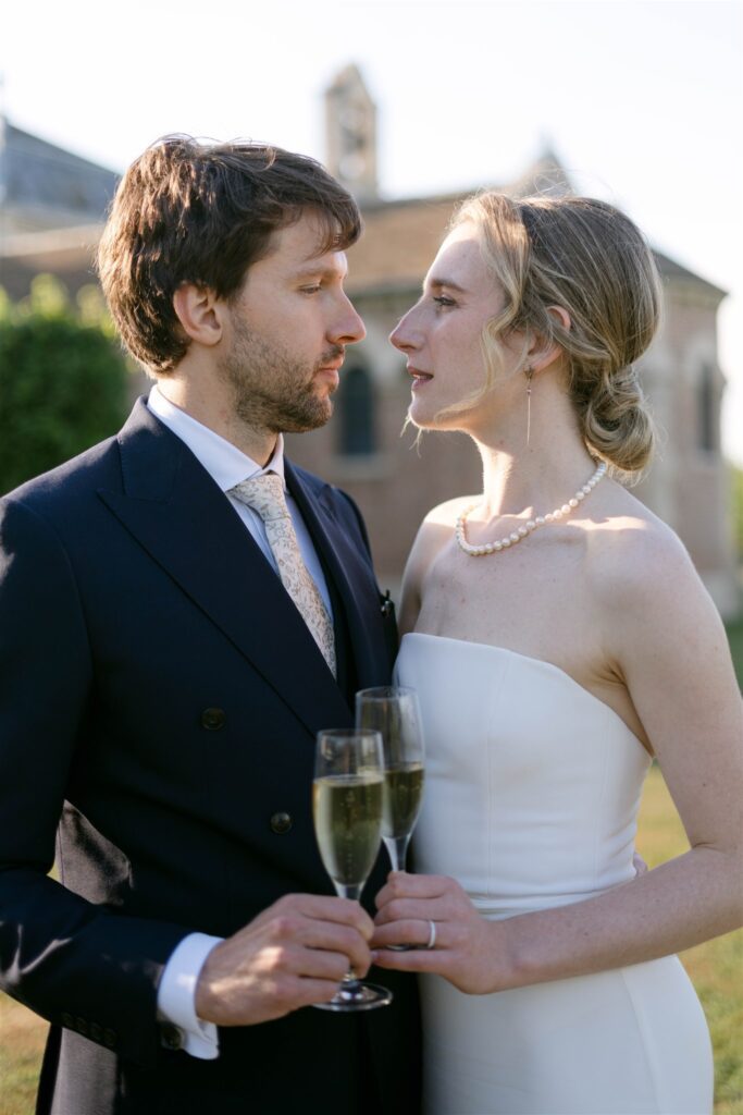 Romy and Jonathan sharing a Champagne toast, their faces close together