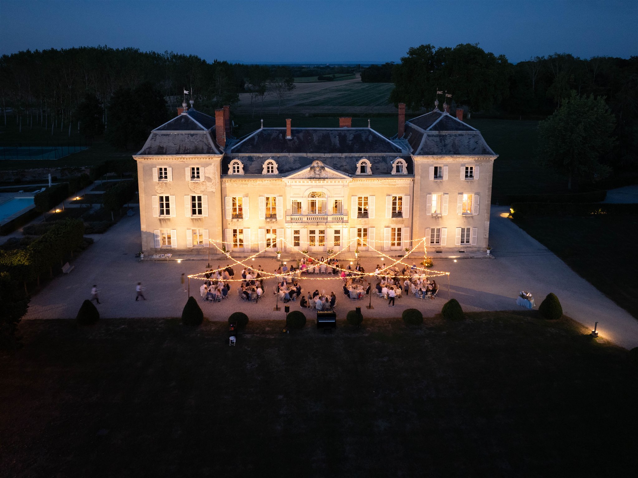 Aerial view of Château de Varennes lit up at dusk