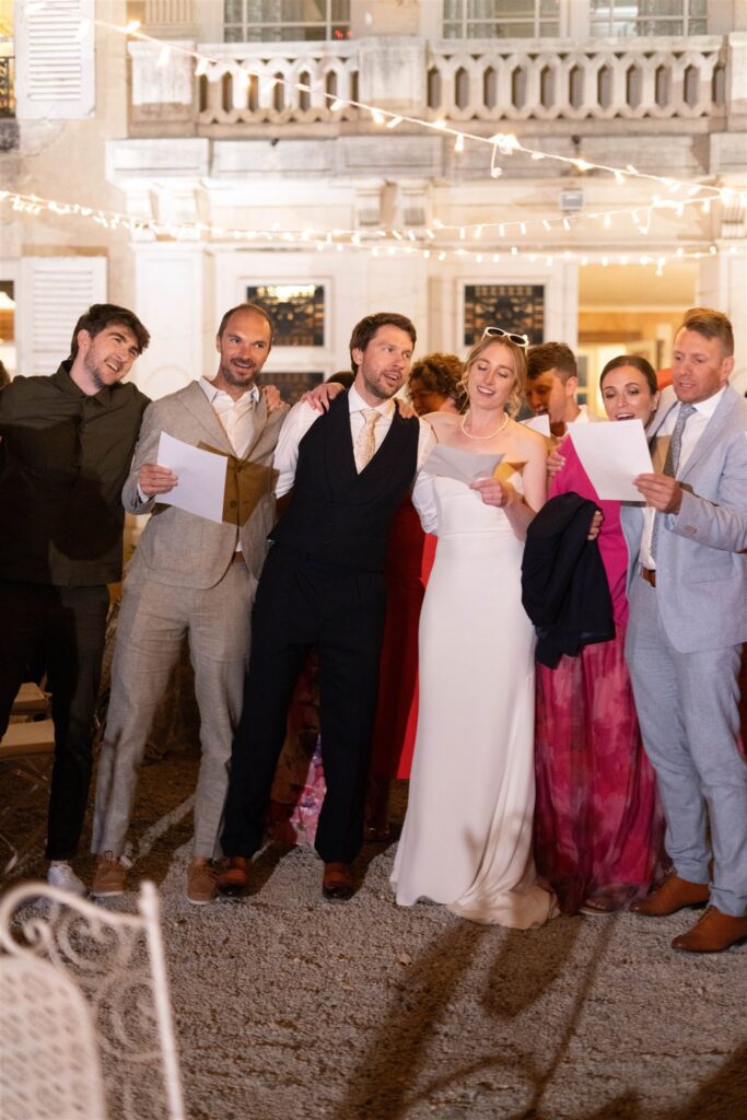 Guests singing together in a circle with Romy and Jonathan at the center