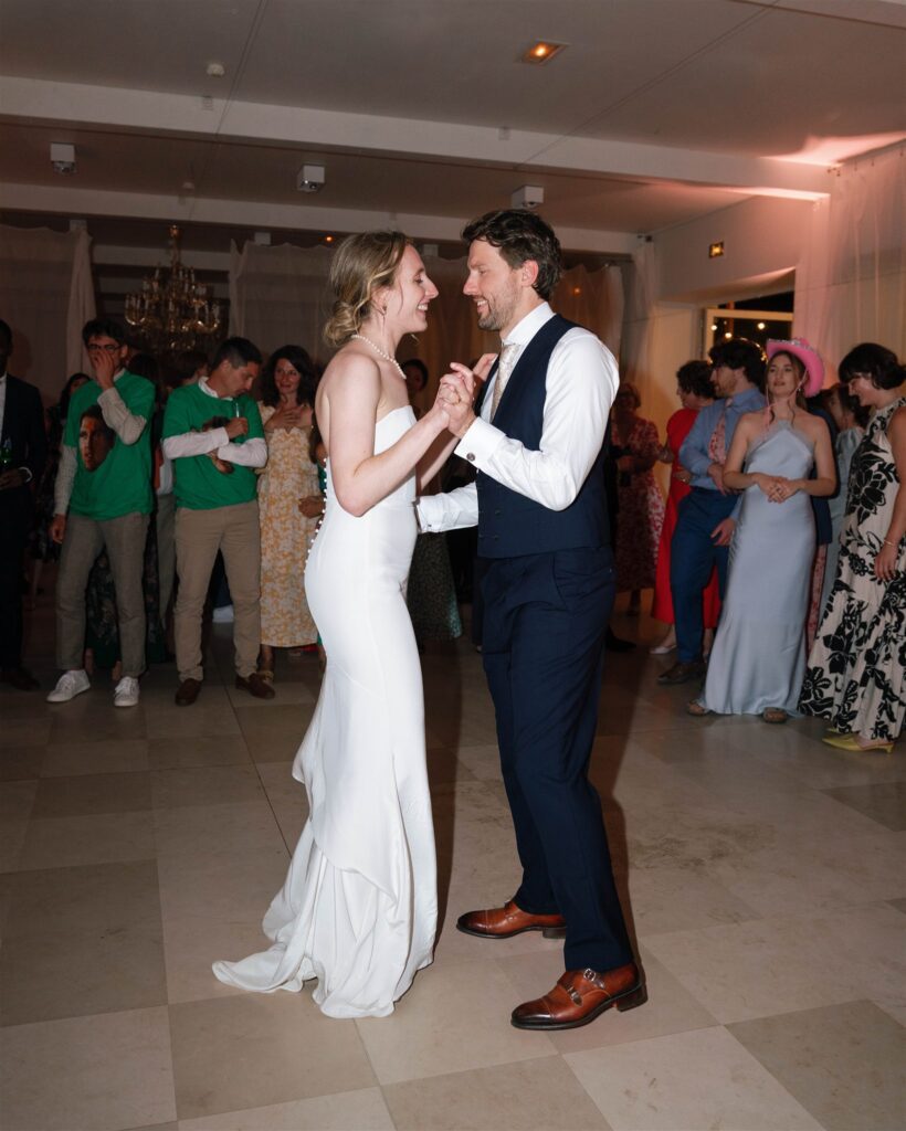 Romy and Jonathan sharing their first dance as guests watch