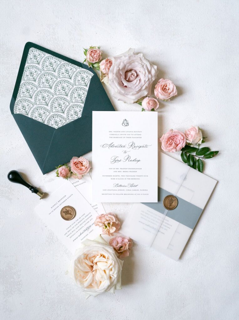 Wedding invitation suite with wax seals, a green envelope and blush roses