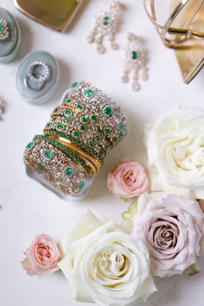 Bridal jewelry and bangles styled with ivory and blush roses