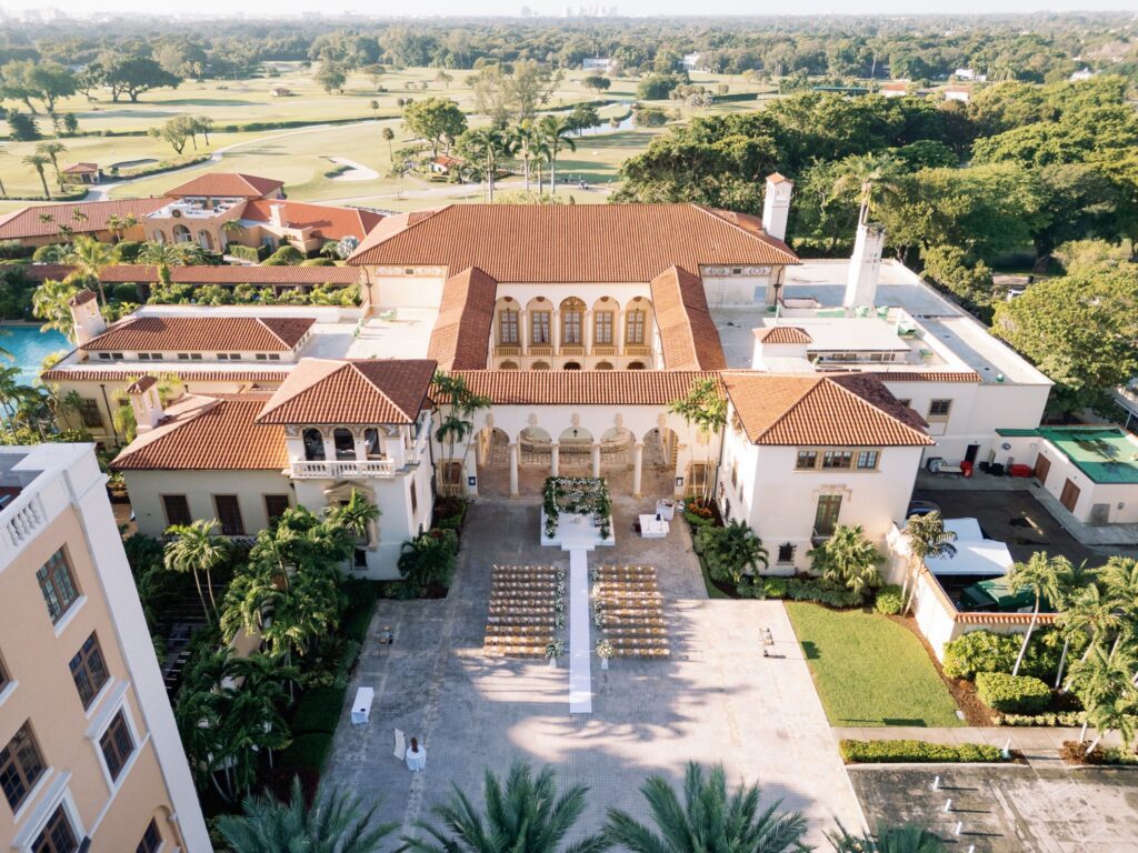 Drone view of the ceremony courtyard with the aisle and chairs set up