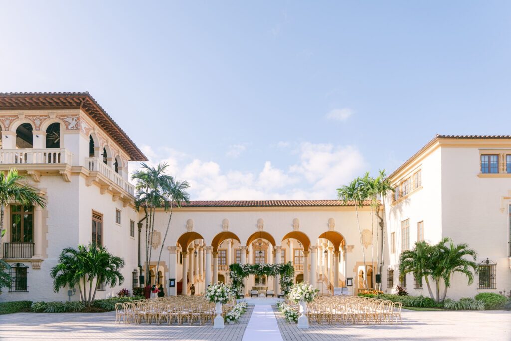 Hindu ceremony courtyard at The Biltmore Hotel with a white aisle and arched loggia