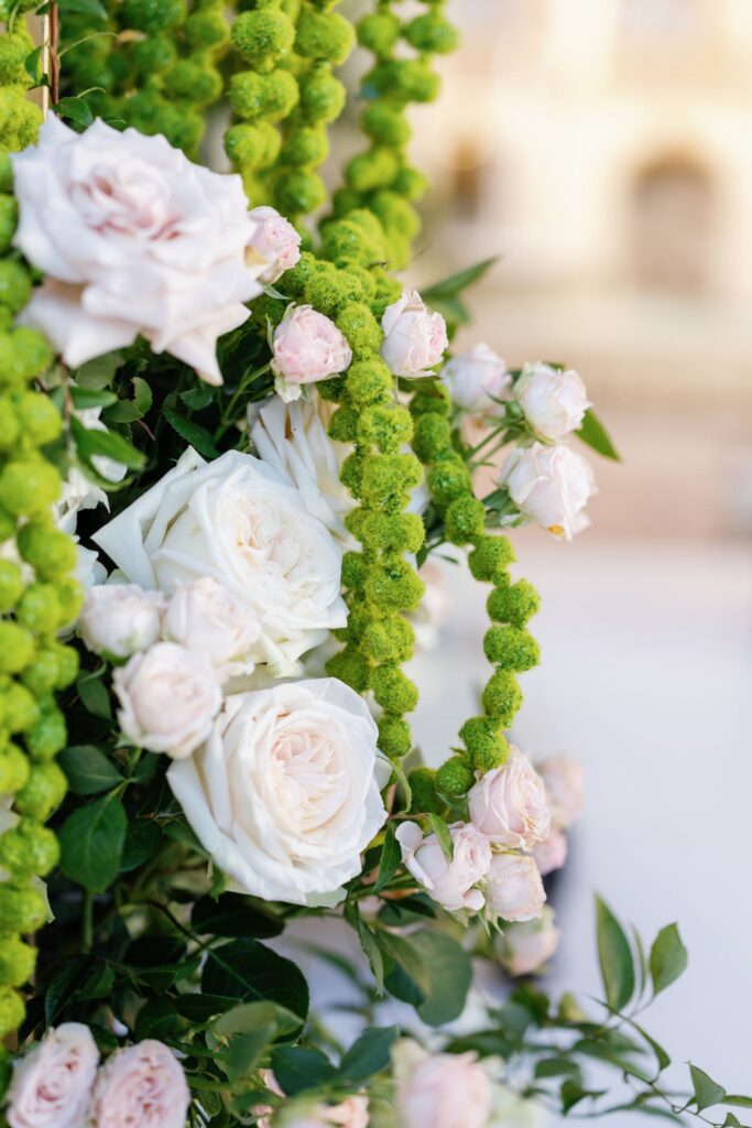 Close-up of white roses and green amaranthus on the mandap