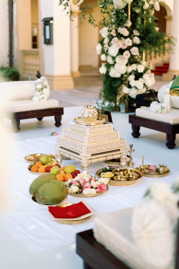 Ceremony altar with fruit, flowers and ritual items beneath the mandap