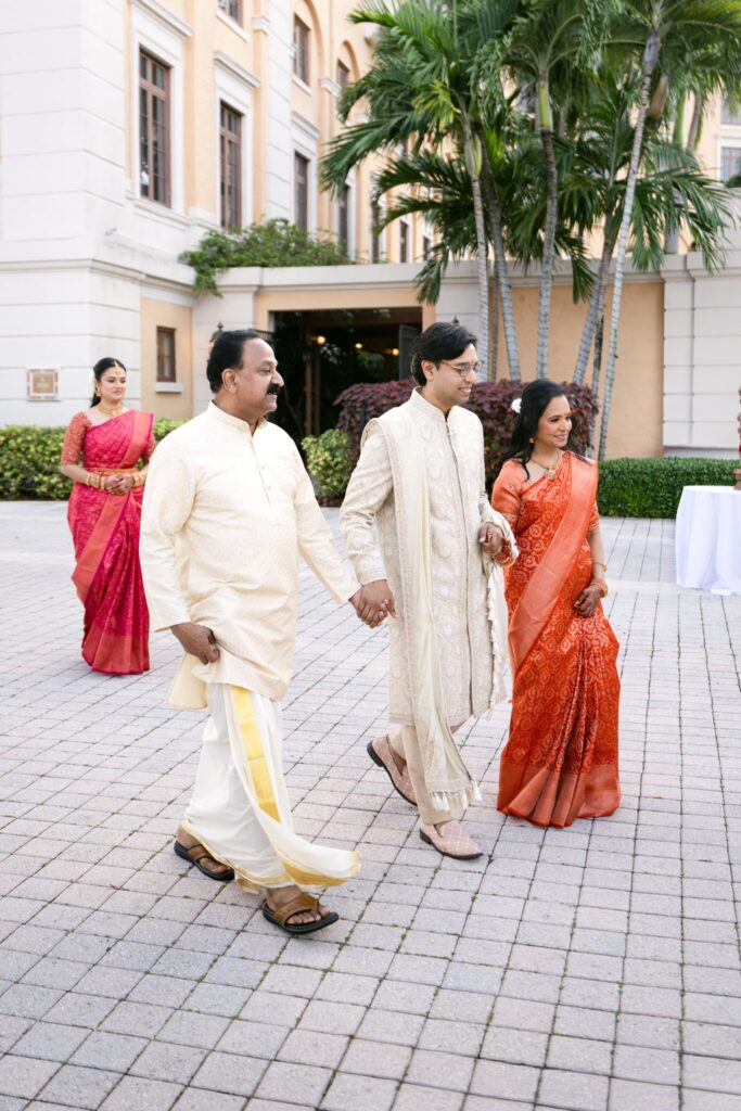 Family members walking hand in hand to the ceremony