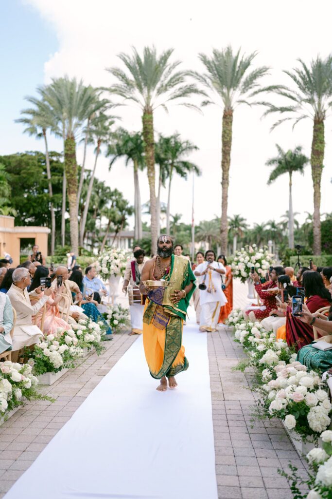 Procession walking down the aisle between guests