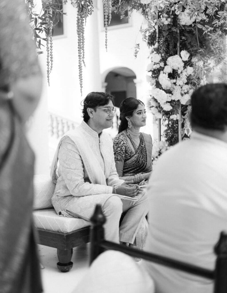 Black and white photo of Tejus and Advaitaa seated at the mandap