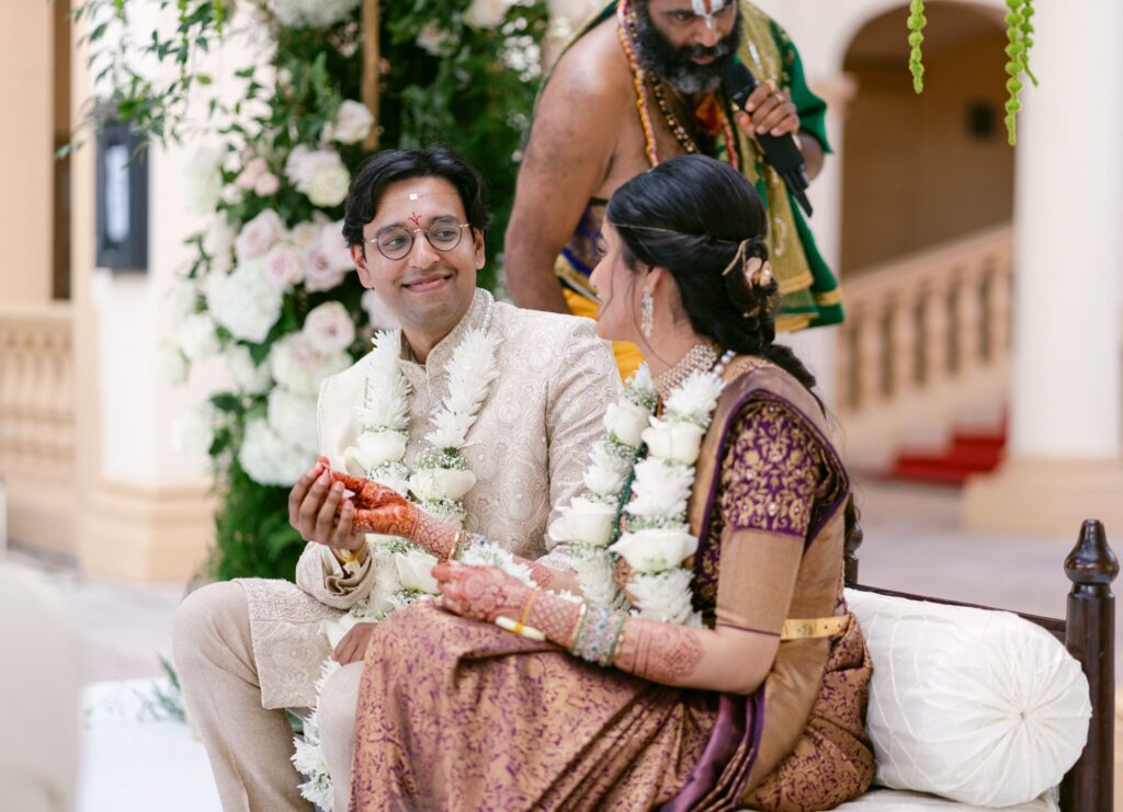 Couple exchanging smiles during a ceremony ritual