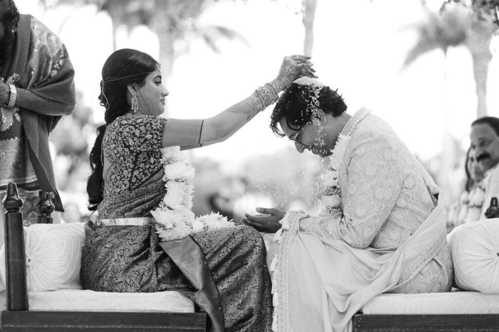 Black and white moment of Advaitaa blessing Tejus during a ceremony ritual