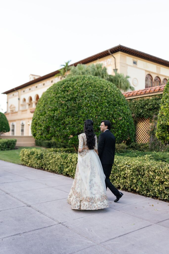Advaitaa and Tejus walking away along a path lined with hedges