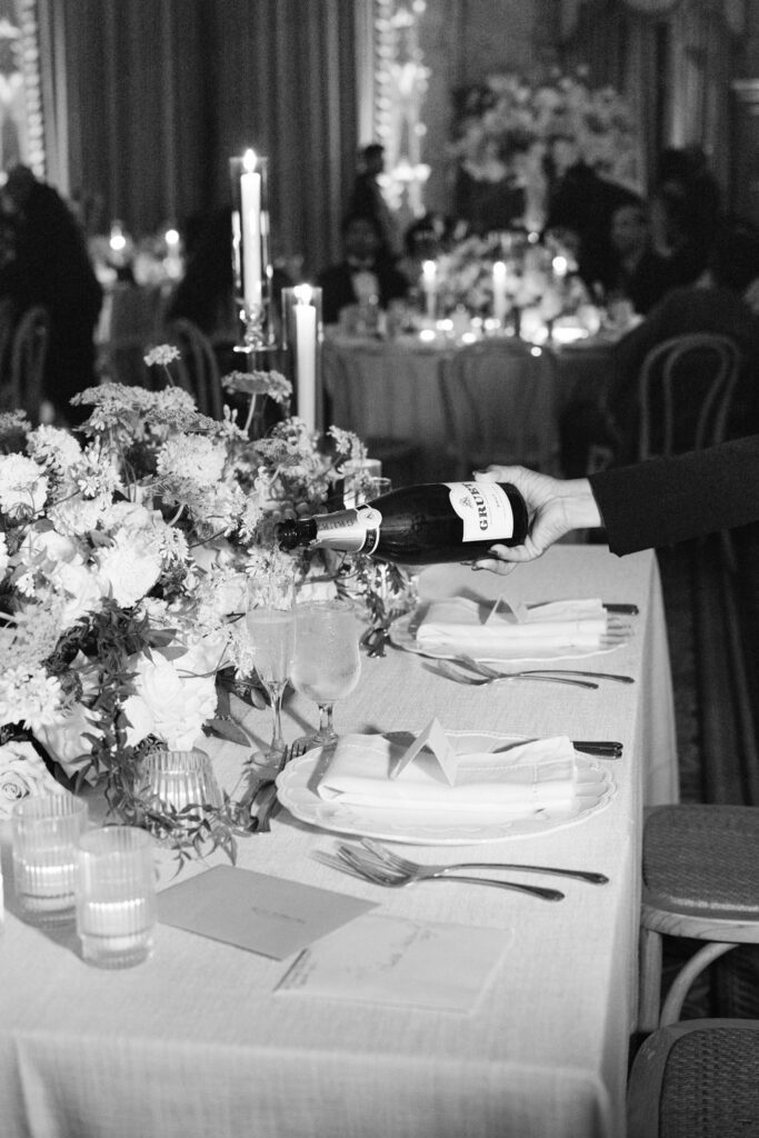 Black and white detail of a floral centerpiece and place setting