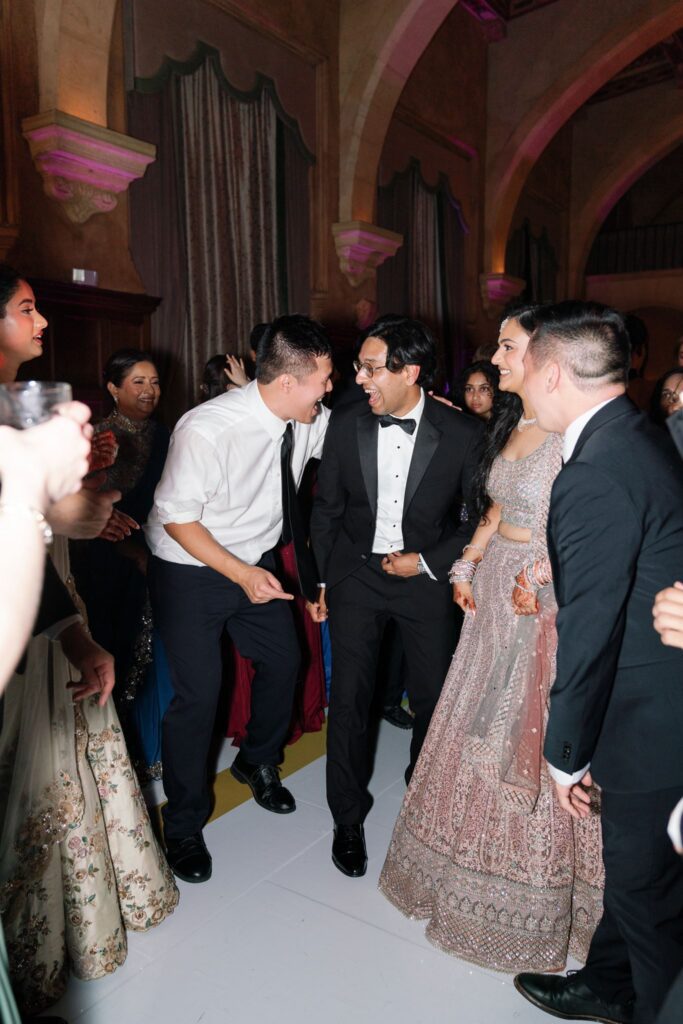 Tejus and friends dancing together on the dance floor