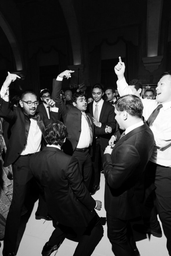 Black and white shot of guests dancing and cheering