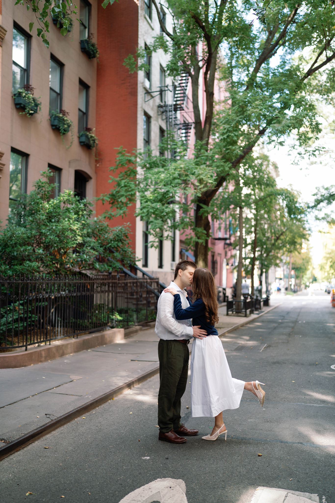 Haley and Jeremy kissing in the middle of street in West Village brownstone