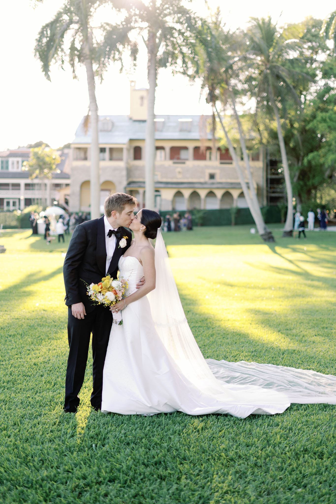 Ashley & Luke kissing in front of the Deering Estate in Miami, FL