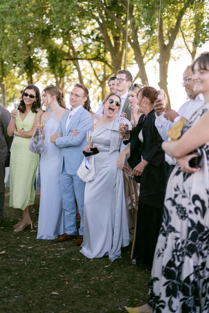 Guests laughing during cocktail hour speeches at Chateau de Varennes