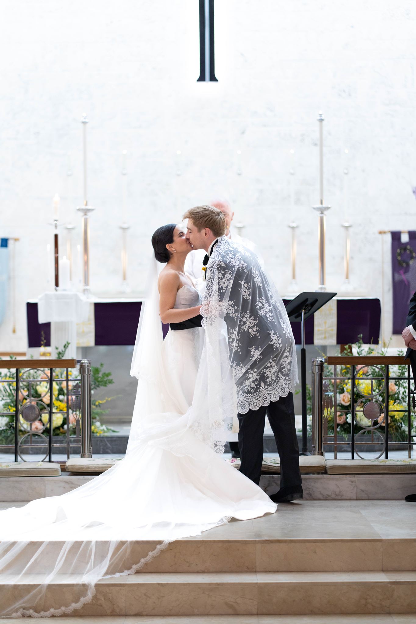 Ashley and Luke sharing their first kiss as husband and wife at the altar
