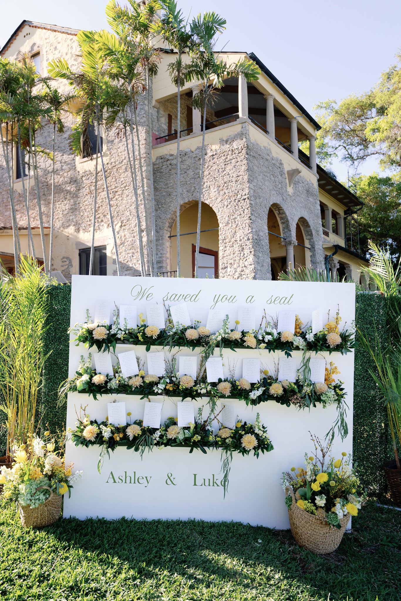 Floral seating chart wall reading We saved you a seat at the Deering Estate