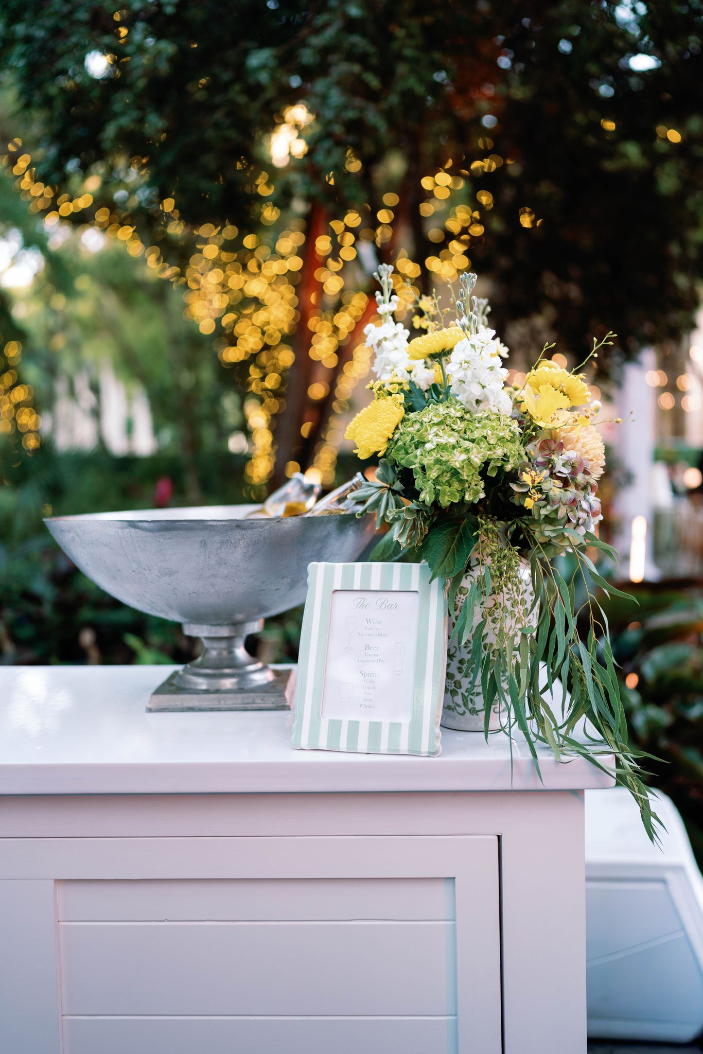 Reception bar with yellow and green flowers at the Deering Estate