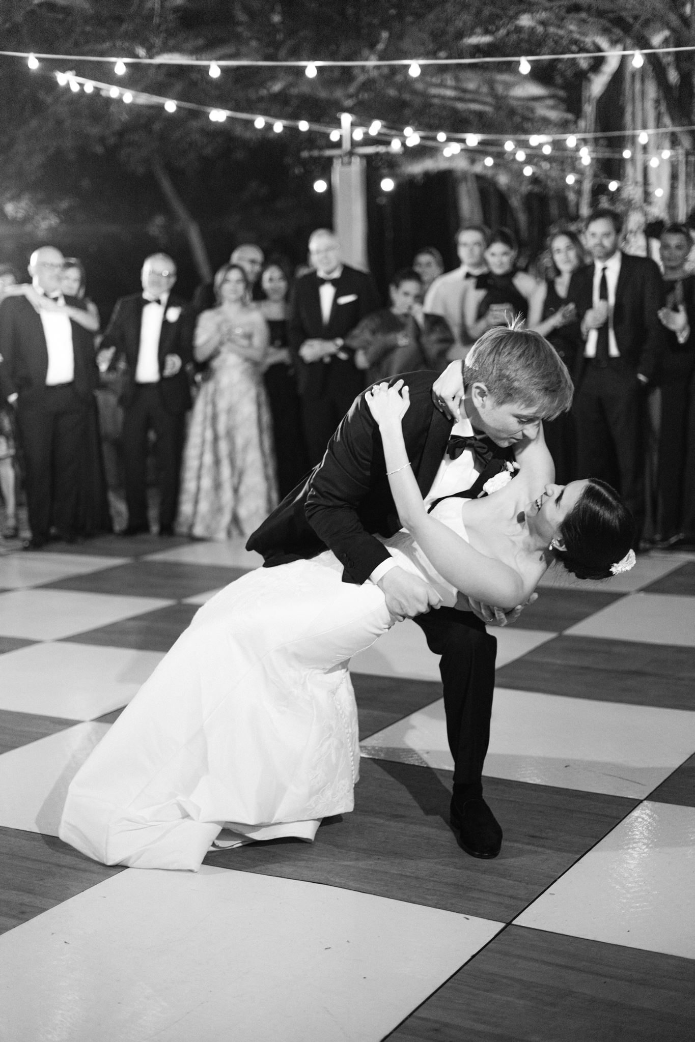 Luke dipping Ashley on the checkerboard dance floor in black and white